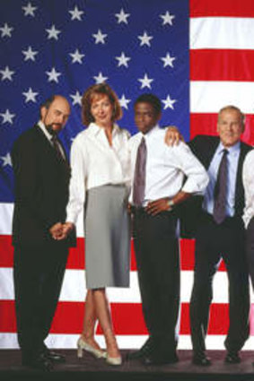 The cast of <i>West Wing</i>: (l-r) Richard Schiff as Communications Director Toby Ziegler; Allison Janney as Press Secretary CJ Gregg, Dule Hill as aide Charlie Young, John Spencer as Chief of Staff Leo McGarry, Martin Sheen as President Josiah Bartlet, Rob Lowe as Deputy Communications Director Sam Seaborn, Janel Moloney as Assistant Donna Moss, Brad Whitford as Deputy Chief of Staff Josh Lyman.