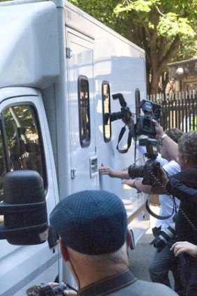 Leaving court: Rolf Harris is taken away after his sentencing.