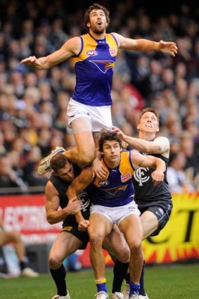 Josh Kennedy rides high but gives away a free against Carlton.