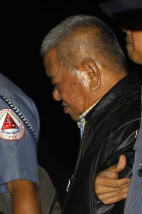 Patriarch ... policemen escort former Maguindanao governor and head of the Ampatuan clan, Andal Ampatuan Sr.