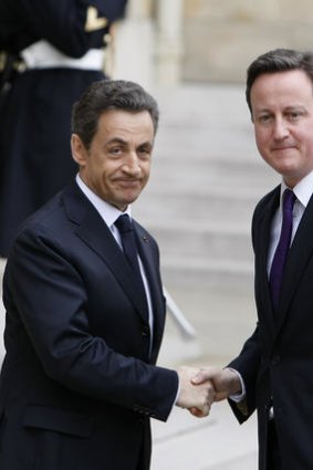 French President Nicolas Sarkozy greets British Prime Minister David Cameron before a crisis summit on Libya earlier this year.