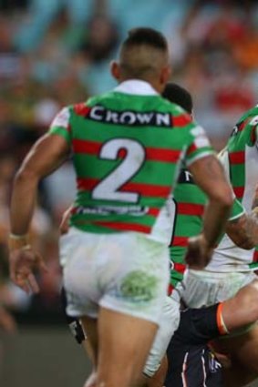 Powerhouse: Rabbitohs prop Sam Burgess gets the ball away to Nathan Merritt in Friday night's game against Wests Tigers.