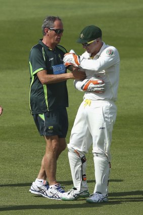 Painful: Brad Haddin gets treatment during the series against Pakistan in the UAE. 