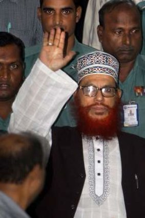 Bangladeshi police officers escort Delwar Hossain Sayeedi, centre. A special war crimes tribunal in Bangladesh sentenced Sayedee to death for crimes stemming from the nation's 1971 fight for independence.