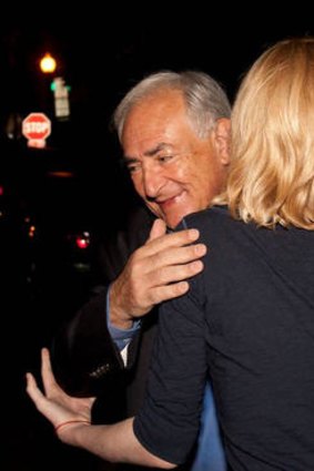 An unidentified woman farewells Dominique Strauss-Kahn.