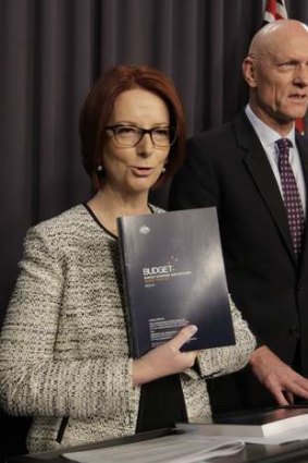 Prime Minister Julia Gillard refers to the 2013 Budget papers with education minister Peter Garrett.