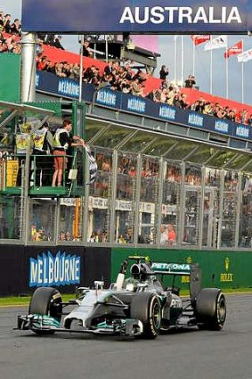 Mercedes driver Nico Rosberg of Germany crosses the finish line to win the 2014 formula one Australian Grand Prix in Melbourne.