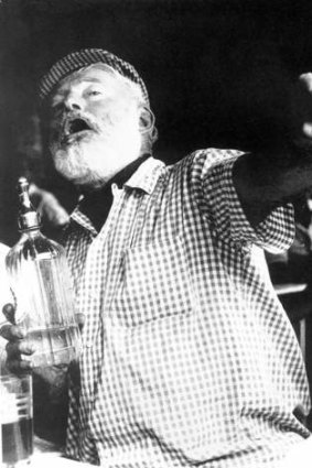 Ernest Hemingway enjoys himself at a bar in Pamplona, Spain, during the annual San Fermin running-of-the-bulls festival in this undated file photo.