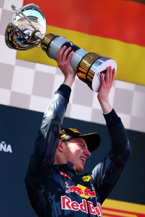 Max Verstappen holds up his trophy.