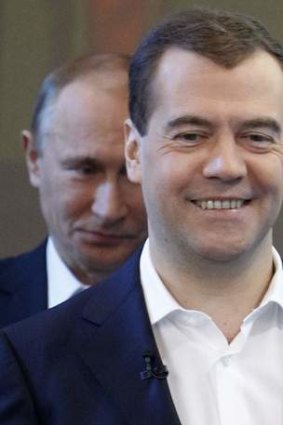 Watch out, he's behind you: Dmitry Medvedev proposed stimulus measures, but it's Vladimir Putin who pulls the strings.