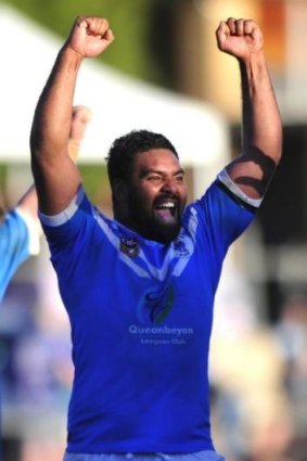 Queanbeyan Blues player Dave Pangai celebrates after winning the 2014 grand final.