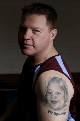 Craig Robberds shows the tattoo of his daughter Gabby who died of Cerebral palsy in 2010.