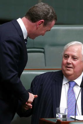 Palmer United Party leader Clive Palmer shakes hands with leader of the house Christopher Pyne after speaking on the carbon tax in the House of Representatives on Monday.