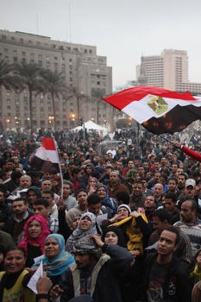 People wave flags as they gather in Cairo's Tahrir Square to celebrate the first anniversary of the revolution against Hosni Mubarak's regime.
