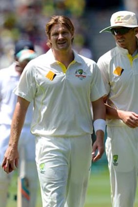 Sore point: Shane Watson is comforted by teammate Peter Siddle after hurting his groin.