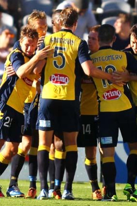 Relief: Mariners players celebrate after their solitary goal against the Roar.