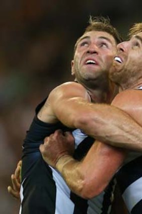 Travis Cloke and Tom Lonergan get physical during the third-round game on Saturday. The relaxed rules on contact in marking contests should have made Cloke unstoppable.