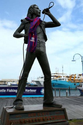A statue of former ACDC lead singer Bon Scott is pictured wearing a Dockers scarf.