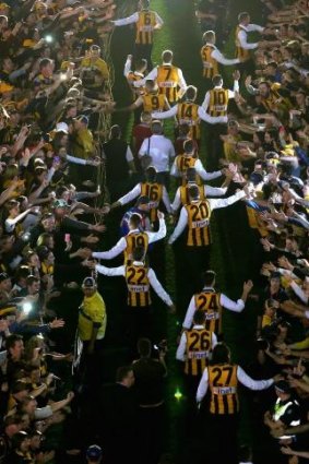 Hawthorn players walk out for the presentation ceremony at the MCG.