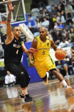 Patrick Mills (right) in action for the Boomers against New Zealand.