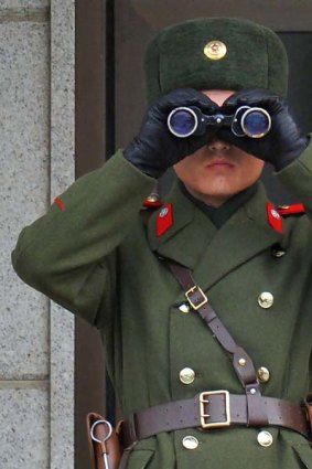 A North Korean soldier looks toward the South side.