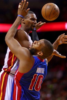 Chris Bosh (left) of the Miami Heat is fouled by Greg Monroe of the Detroit Pistons.