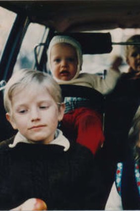 A rear-facing Simon Castles, second from left, and siblings in the Volvo.