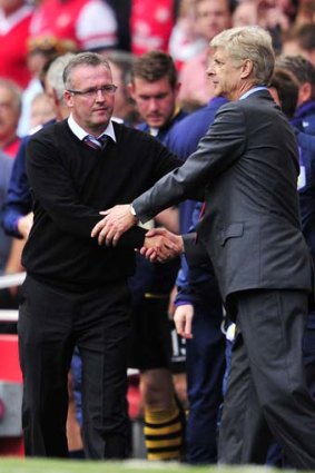 Aston Villa manager Paul Lambert shakes hands with Arsenal manager Arsene Wenger.