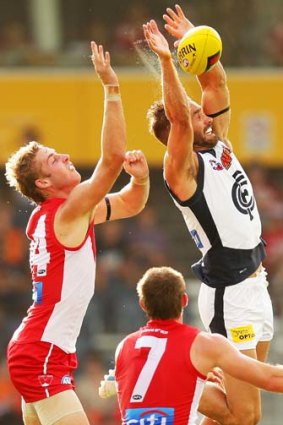 Andrew Walker of the Blues attempts a mark in front of Alex Johnson of the Swans.