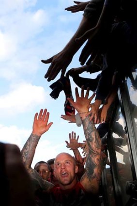 Sharing the joy:  Nathan Jones high-fives the fans after Melbourne beat Carlton.