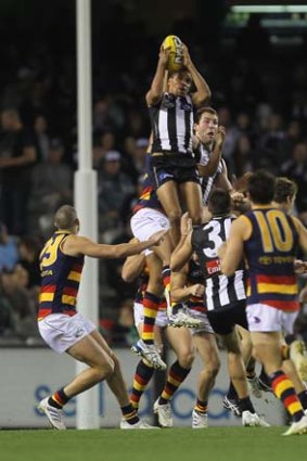 Andrew Krakouer of the Magpies takes a mark.