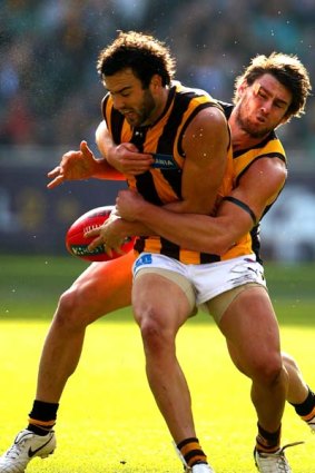 Hawk Jordan Lewis is tackled by Chris Newman of the Tigers during their match at the MCG.