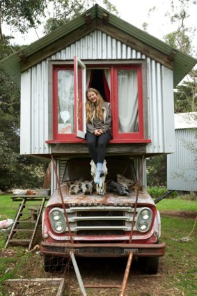 Hailey Scott sits in her bedroom window in the granny flat built on the back of an old truck by her dad Rob.