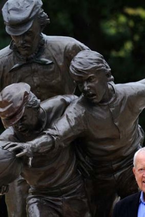 Dr Allen Aylett in front of Tom Wills statue at the MCG.