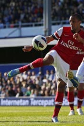 In the way: Theo Walcott has his shot blocked. Photo: Reuters