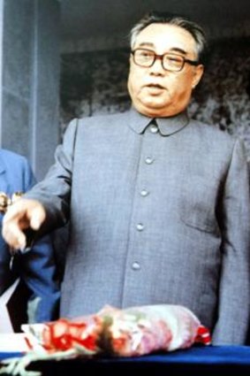 North Korea's founder, Kim Il-sung, chats to a younger Kim Jong-il at a 1983 rally in Pyongyang.