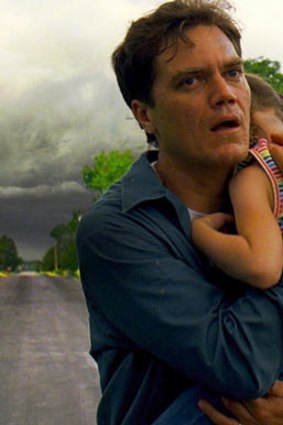 Bad forecast: Curtis (Michael Shannon) huddles his son against the oncoming storm in the extraordinary, quiet drama <i>Take Shelter</i>.
