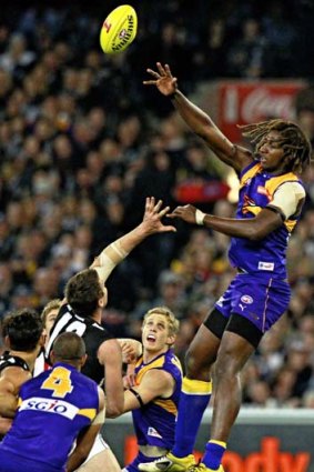Eagles ruckman Nic Naitanui soars over his opponent at a centre bounce.