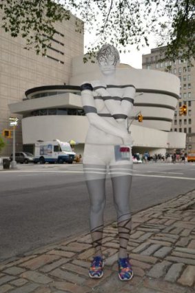 A model appears to blend into the background as she stands in front of the Guggenheim Museum in New York.