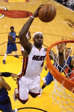 Miami Heat's LeBron James dunks during his team's win over Dallas Mavericks.