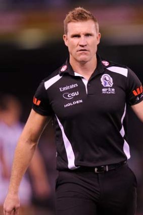 Collingwood coach Nathan Buckley watches the game.