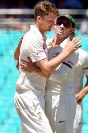 Jackson Bird congratulated by Michael Hussey after taking 3/76.