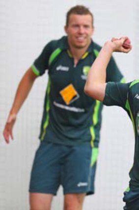 Ball sense: James Pattinson throws the ball at training on Monday as Peter Siddle looks on.