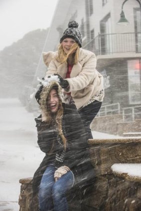 Terry Saggers (below) and Hannah Bowes enjoy the fresh snow that fell on Mt Buller today.