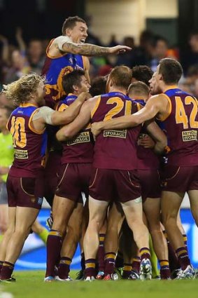 The Lions celebrate after defeating Geelong in round 13. Voss' axing has come at a time when the team has recorded five wins in its last eight games.