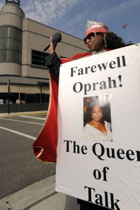 An Oprah fan stands outside Harpo Studios.