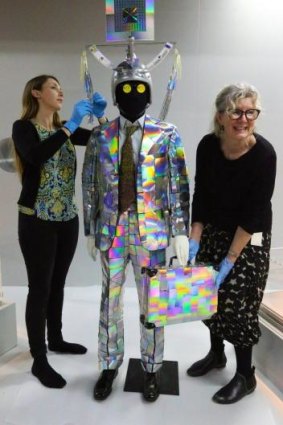 Disco-a-go-go: Alexandra Lucas and curator Glynis Jones dress a mannequin in the suit formerly worn by Peter Tully.