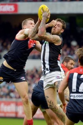 Pie-eyed: Collingwood's Dane Swan cops some attention from Demon Tom McDonald.