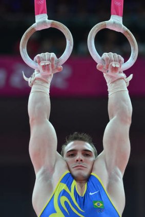 Muscling up ... Zanetti's biceps bulge as he hangs on the rings.