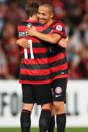 Shinji Ono and Brendon Santalab of the Wanderers embrace after the final whistle against Kawasaki Frontale.